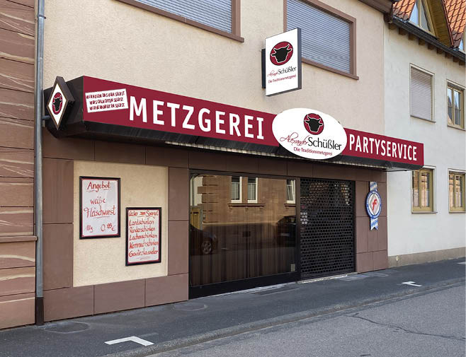 Foto der Metzgerei Schüssler Filiale in Wörth. Hausansicht mit davor liegender Straße.